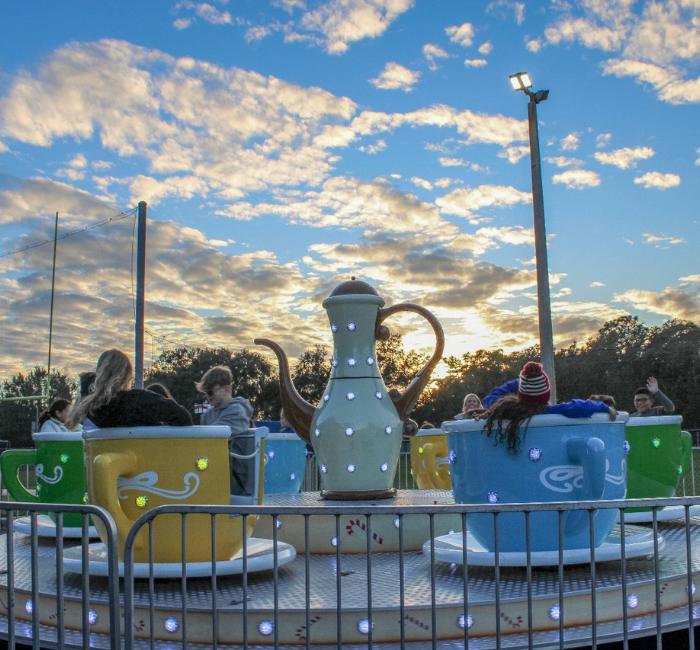 teacups ride rental set up with riders enjoying the ride